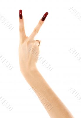 hand with long acrylic nails showing victory sign