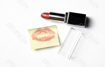 red lipstick and yellow sticker note with kiss