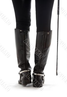 beautiful legs in black leather horseman boots with riding-crop beautiful legs in black leather horseman boots with riding-crop