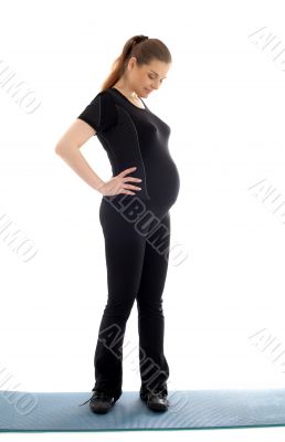 lovely pregnant woman in black working out