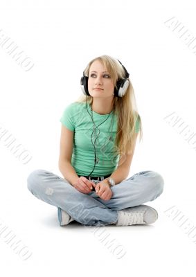 teenage girl in headphones sitting on the floor