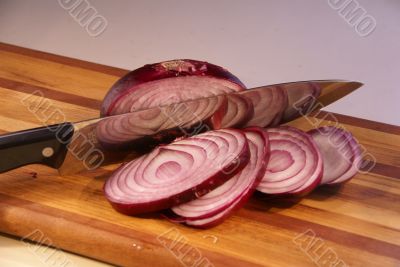 Sliced red onion and knife
