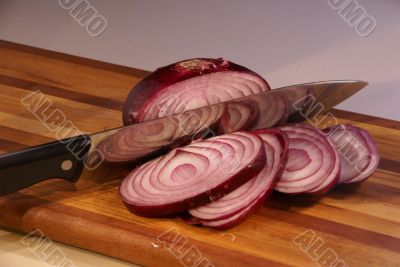 Sliced red onion and knife