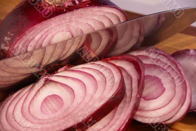 Sliced red onion and knife