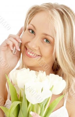 cheerful blond with white tulips and phone