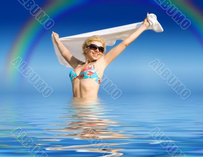 happy girl with towel standing in water