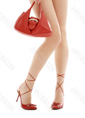 long legs on high heels and red purse