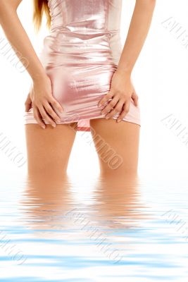 lady in pink shiny dress standing in water