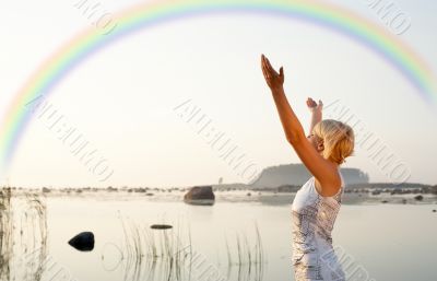 pretty blond raising hands to the rainbow