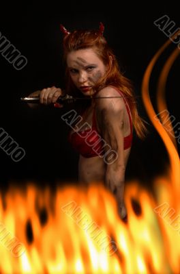 dark red devil girl with a knife in fire