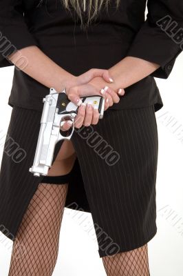 A gun behind her back