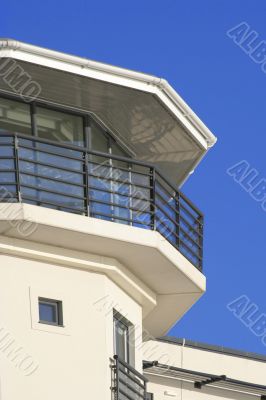 a building, against a plain blue sky.