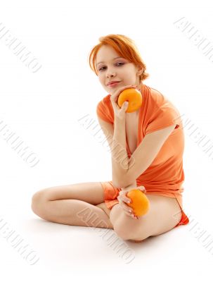 cheerful redhead with two oranges