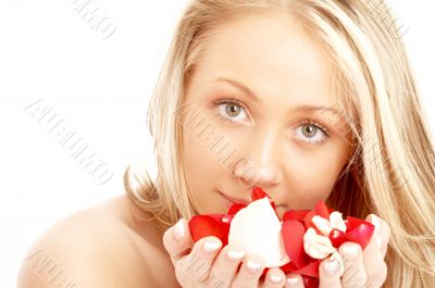 happy blond in spa with red and white petals