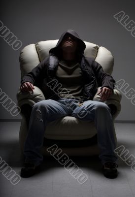 dangerous man sitting in white chair