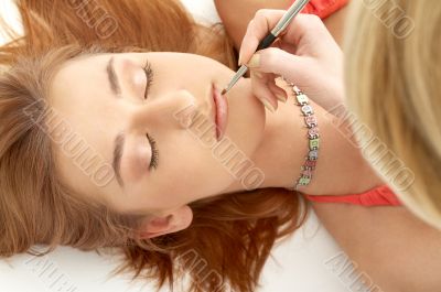 redhead laying at professional makeup studio