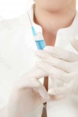 hands in rubber gloves with syringe