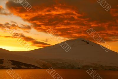 Fiery sunset over icy mountain