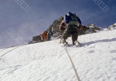 Climbers on steep snow face