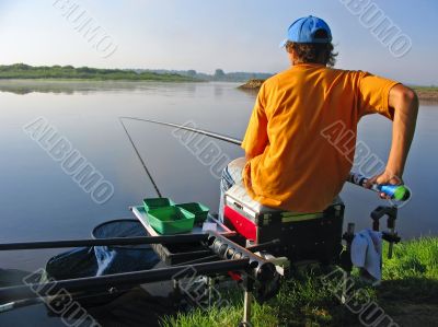 Seated man fishing