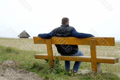 Man is sitting on a bench Man is sitting on a bench