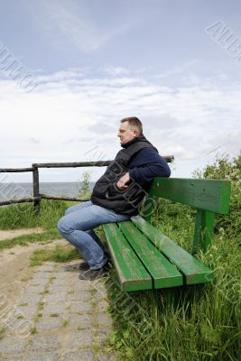 Man is sitting on a bench Man is sitting on a bench