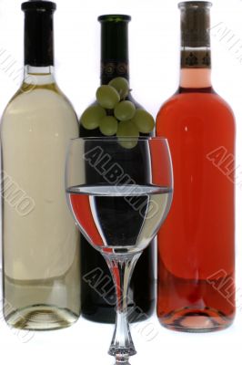 wine glasses with reflection of  wine bottles