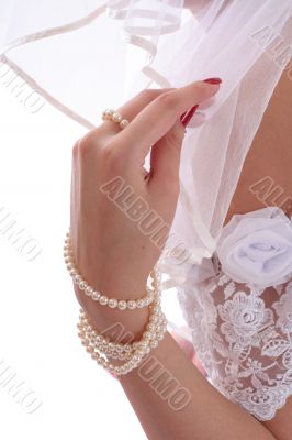 Hand touching a bridal veil
