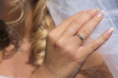 Hand touching a bridal veil