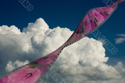 Film on a background of the cloudy sky