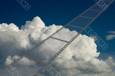 Film on a background of the cloudy sky