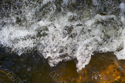 little rapids and spray in a small river