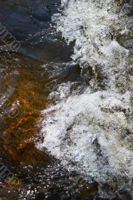 little rapids and spray in a small creek