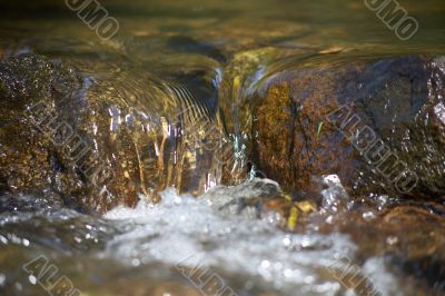 little rill with brown stones and rocks