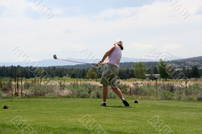Lady golfer hitting ball from tee