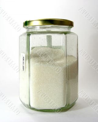 Glass jar with white a granulated sugar