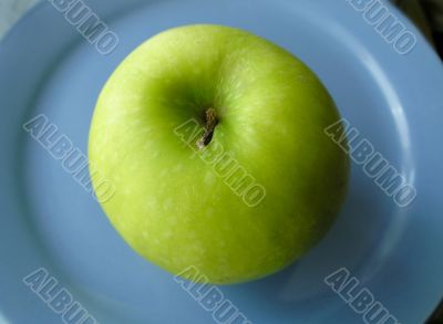 Apple on blue plate