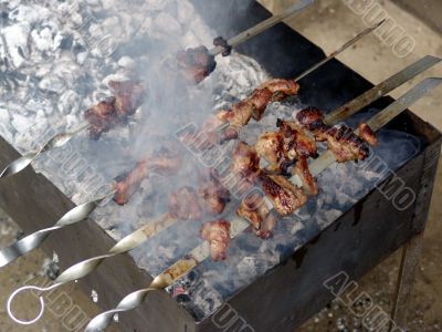 Meat is fried on bonfire