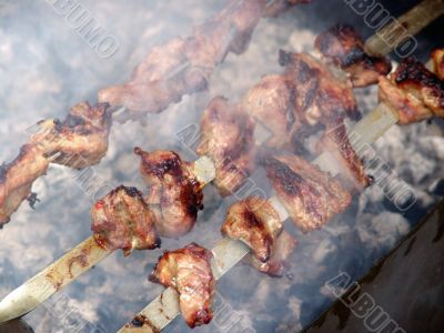Meat is fried on bonfire