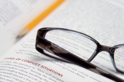 spectacles and pencil