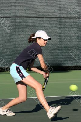 Young girl playing tennis