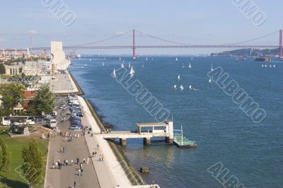 wide river with yachts and modern bridge