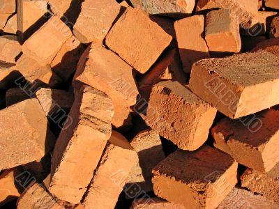 Pile of a cracked red bricks