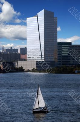 skyscraper with sail boat and waterview
