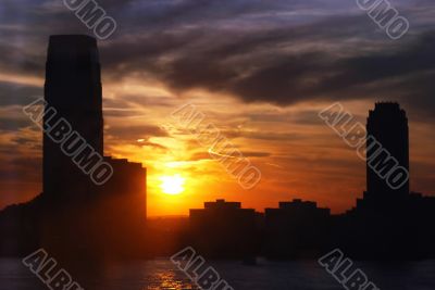 skyline and skyscrapers with water and setting sun