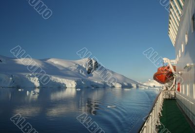 Cruise ship with lifeboat, mountains