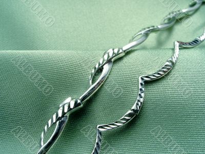 Bracelets on green drapery