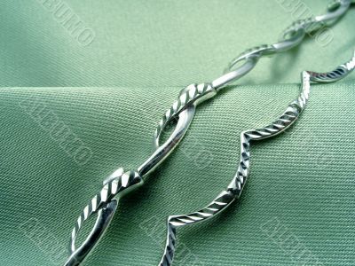 Bracelets on green drapery