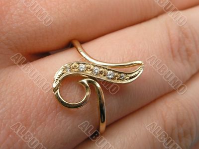 Golden ring on a hand of the girl