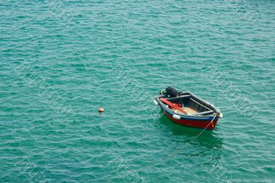 red fishing boat in green waters